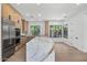 Modern kitchen features a large marble island, stainless steel appliances, and sleek wooden cabinetry at 31107 N 72Nd Pl, Scottsdale, AZ 85266