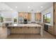 Bright kitchen with natural wood cabinets, stainless appliances, and a large center island with a marble countertop at 31107 N 72Nd Pl, Scottsdale, AZ 85266