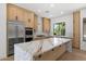 Spacious kitchen with a large island with marble countertop and sleek wooden cabinetry at 31107 N 72Nd Pl, Scottsdale, AZ 85266