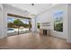 Open living room with wood floors, built-in shelves, and expansive views of the outdoor pool area at 31107 N 72Nd Pl, Scottsdale, AZ 85266