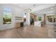 Open-concept living room with wood floors, bar, and an expansive view of the kitchen at 31107 N 72Nd Pl, Scottsdale, AZ 85266