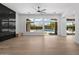 Open living room with wood floors, large windows, and backyard views with a pool at 31107 N 72Nd Pl, Scottsdale, AZ 85266