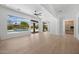 Spacious living room featuring wood floors, expansive windows, and convenient access to the kitchen at 31107 N 72Nd Pl, Scottsdale, AZ 85266