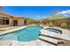 Sparkling pool with spa featuring stone pavers and lush landscaping at 31107 N 72Nd Pl, Scottsdale, AZ 85266