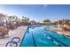 Resort-style swimming pool with lap lanes, lounge chairs, and stone accents under a clear blue sky at 31107 N 72Nd Pl, Scottsdale, AZ 85266