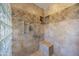 This bathroom features neutral tile, glass block window, built in shower niche, and shower bench at 3357 N Ashbrook E St, Mesa, AZ 85213