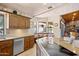 Traditional-style kitchen features granite counters, stainless steel appliances, and breakfast nook with bright natural light at 3357 N Ashbrook E St, Mesa, AZ 85213