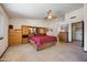 Large main bedroom with tile flooring and wood dresser built-in with mirrored accents at 3357 N Ashbrook E St, Mesa, AZ 85213