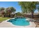 Beautiful backyard pool with a waterfall feature and lush greenery at 3357 N Ashbrook E St, Mesa, AZ 85213