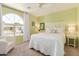 Comfortable bedroom with a large window, white furnishings, and neutral tones at 3619 E Thornton Ave, Gilbert, AZ 85297