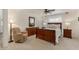 Charming bedroom with a wooden bed frame, soft carpet, and relaxing sitting area at 3619 E Thornton Ave, Gilbert, AZ 85297
