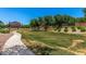 Well-maintained community park with green space, walking path, playground, and mature trees for recreational activities at 3619 E Thornton Ave, Gilbert, AZ 85297