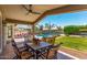 Relaxing covered patio with a dining table set, perfect for enjoying the backyard pool and lounge chairs at 3619 E Thornton Ave, Gilbert, AZ 85297
