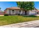 Well-maintained home with a manicured lawn, desert landscaping, arched windows, and a two-car garage at 3619 E Thornton Ave, Gilbert, AZ 85297