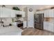Bright kitchen features white cabinets, stainless steel appliances, and wood-look tile flooring at 3619 E Thornton Ave, Gilbert, AZ 85297