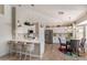 Spacious kitchen featuring a breakfast bar, stainless steel appliances, and an adjacent dining area at 3619 E Thornton Ave, Gilbert, AZ 85297
