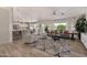 Open-concept living room with wood floors, neutral decor, ceiling fan, and abundant natural light at 3619 E Thornton Ave, Gilbert, AZ 85297