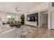 Stylish living room with comfortable seating, accent pillows, designer rug, and modern entertainment center at 3619 E Thornton Ave, Gilbert, AZ 85297