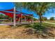 Community playground under a shade structure with benches, slides, and play areas for children at 3619 E Thornton Ave, Gilbert, AZ 85297