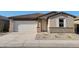 Charming single-story home featuring a two-car garage and a beautifully landscaped front yard with stone accents at 37427 W San Sisto Ave, Maricopa, AZ 85138