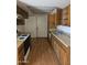 Kitchen featuring laminate wood floors, cabinets, and ample countertop space at 3807 W Mitchell Dr, Phoenix, AZ 85019