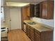 Kitchen featuring laminate wood floors, cabinets, and appliances at 3807 W Mitchell Dr, Phoenix, AZ 85019