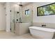 Bright bathroom featuring a soaking tub and a glass enclosed walk-in shower at 3848 E Fairmount Ave, Phoenix, AZ 85018