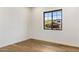 Well-lit bedroom with wood floors and a view of the neighborhood at 3848 E Fairmount Ave, Phoenix, AZ 85018
