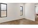A bright bedroom with wood floors and a view to the backyard at 3848 E Fairmount Ave, Phoenix, AZ 85018