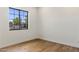 Bedroom with wood floors and a large window with neighborhood view at 3848 E Fairmount Ave, Phoenix, AZ 85018