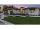 Beautiful exterior featuring a well-manicured lawn, black accents, and a freshly painted white facade at 3848 E Fairmount Ave, Phoenix, AZ 85018