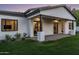 Home's exterior showcases a covered patio, manicured lawn, and modern design under a beautiful twilight sky at 3848 E Fairmount Ave, Phoenix, AZ 85018