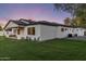 Home's exterior and manicured lawn, under a twilight sky, creating a serene and inviting atmosphere at 3848 E Fairmount Ave, Phoenix, AZ 85018
