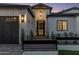 Stunning home exterior featuring a modern design, black framed windows, and a welcoming entrance at twilight at 3848 E Fairmount Ave, Phoenix, AZ 85018