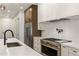 Gourmet kitchen with quartz countertops, stainless steel appliances, a pot filler, and designer finishes at 3848 E Fairmount Ave, Phoenix, AZ 85018