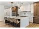 Spacious kitchen with an oversized island, seating for six, and hardwood floors in an open-concept design at 3848 E Fairmount Ave, Phoenix, AZ 85018