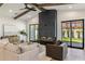 Cozy living room with a modern fireplace, exposed wood beams, and plenty of natural light and designer finishes at 3848 E Fairmount Ave, Phoenix, AZ 85018