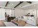 Inviting living room featuring exposed beams, neutral decor, and an open layout, perfect for entertaining at 3848 E Fairmount Ave, Phoenix, AZ 85018