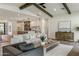 Open-concept living room with wooden beams and hardwood floors flows into the kitchen at 3848 E Fairmount Ave, Phoenix, AZ 85018