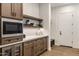 Stylish mudroom with custom cabinets, a beverage center, and a convenient entrance to the home at 3848 E Fairmount Ave, Phoenix, AZ 85018