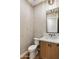 Stylish powder room features wood cabinetry, modern black hardware, and a sleek, minimalist design at 3848 E Fairmount Ave, Phoenix, AZ 85018