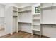 Bright walk-in closet with custom built-in shelving and a small window at 3848 E Fairmount Ave, Phoenix, AZ 85018
