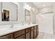 The primary bathroom has a double vanity, a large mirror, and a glass door shower stall at 3900 E Baseline Rd # 166, Phoenix, AZ 85042