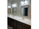 Bathroom with dual sinks, large mirrors, and modern lighting fixtures at 3900 E Baseline Rd # 166, Phoenix, AZ 85042