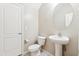Half bathroom with modern fixtures, pedestal sink, and tile flooring at 3900 E Baseline Rd # 166, Phoenix, AZ 85042