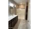 Bathroom featuring dark cabinetry, a long countertop, and a glass-enclosed shower at 3900 E Baseline Rd # 166, Phoenix, AZ 85042