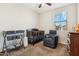 A Bedroom featuring a dark wood crib, glider chair, and changing table at 3900 E Baseline Rd # 166, Phoenix, AZ 85042
