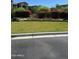 Well-maintained community lawn area with flower beds and lush green landscaping at 3900 E Baseline Rd # 166, Phoenix, AZ 85042