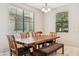 Cozy dining room with a wooden table and seating for six, illuminated by a chandelier at 3900 E Baseline Rd # 166, Phoenix, AZ 85042