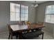 Dining room with a wooden table, bench, and chairs under a modern chandelier at 3900 E Baseline Rd # 166, Phoenix, AZ 85042